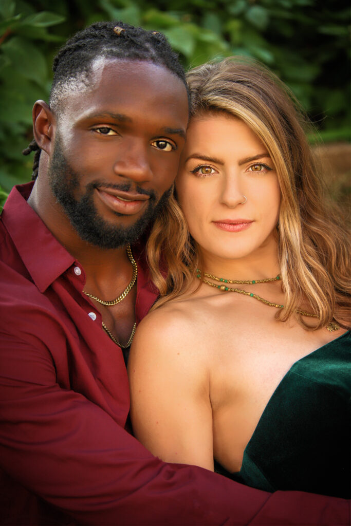 Intimate fine art couple’s portrait with rich colors, capturing a close embrace and genuine connection.