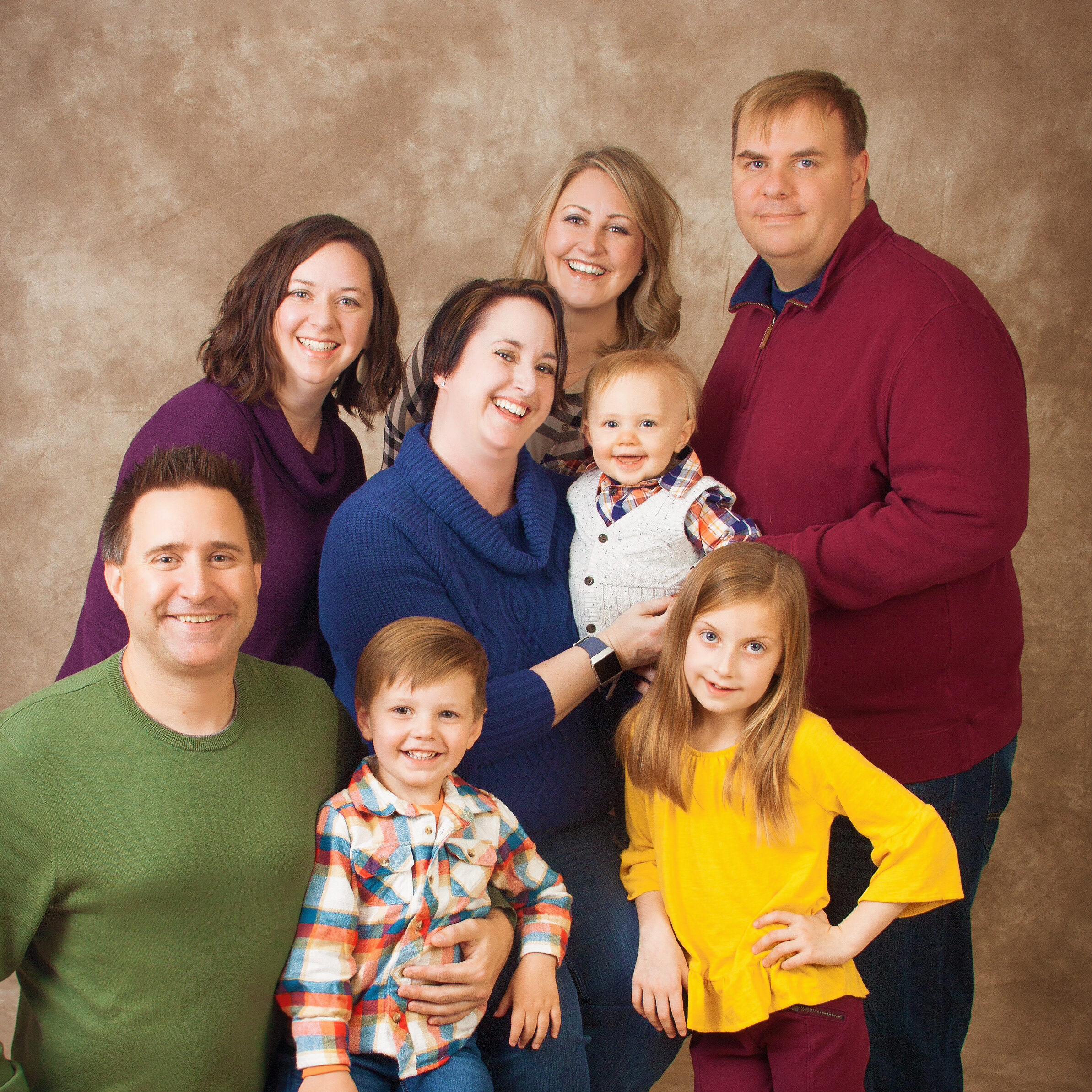 Joyful fine art family portrait of three generations, studio setting, designed as a lasting legacy heirloom.
